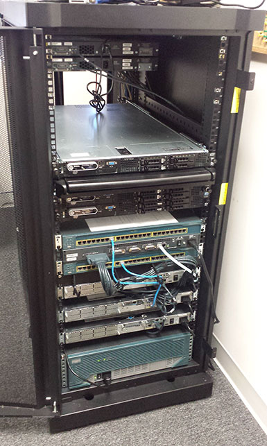 Byron's home lab: a server rack with Dell PowerEdge servers and Cisco switches and routers